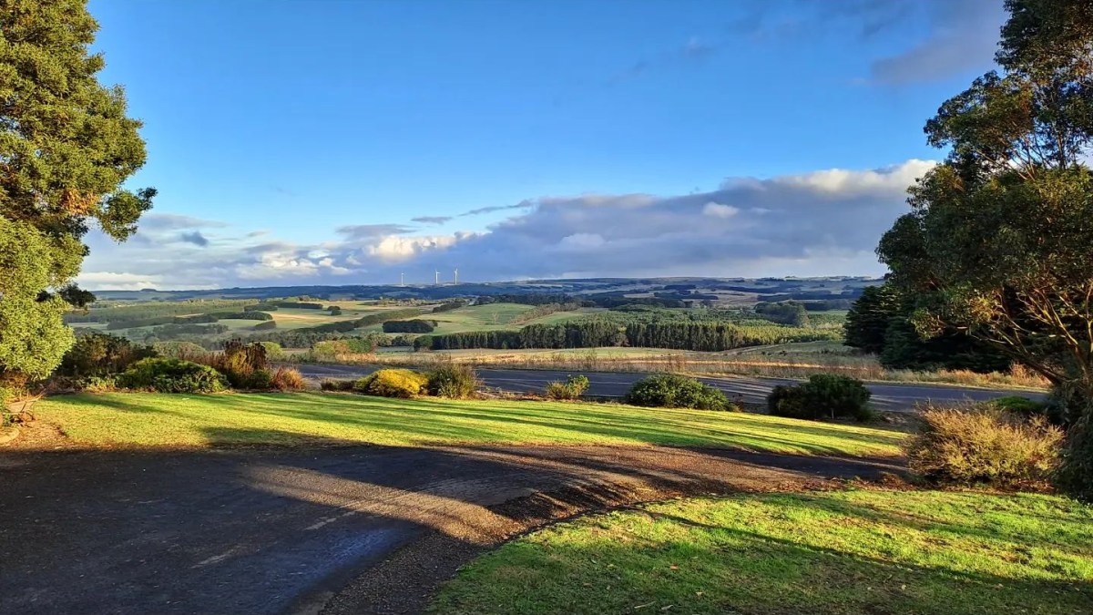 Rolling green hills and farmland under a big blue sky