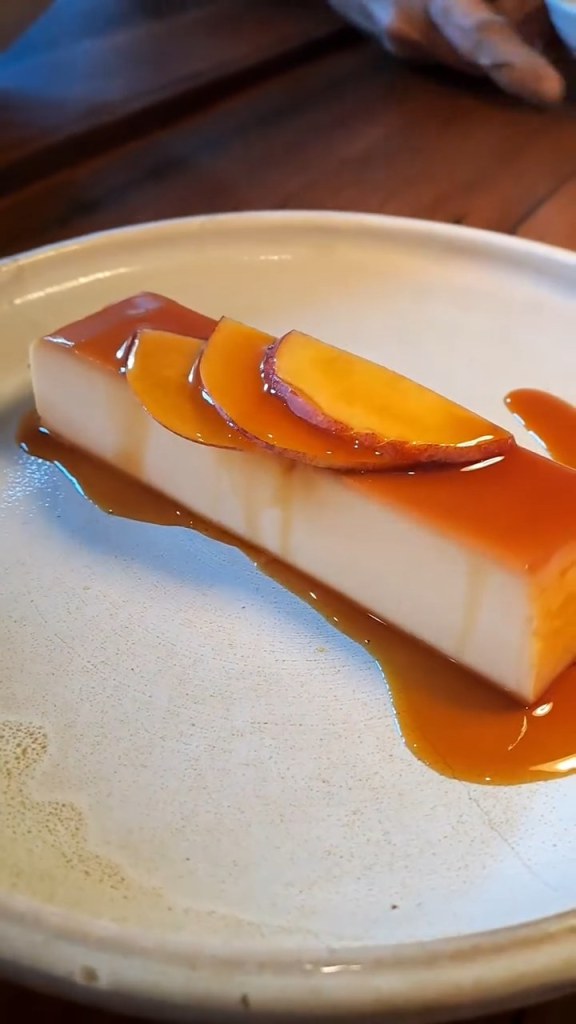 A custard dessert with caramel and fruit