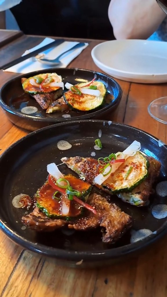 A colourful starter served on dark plates