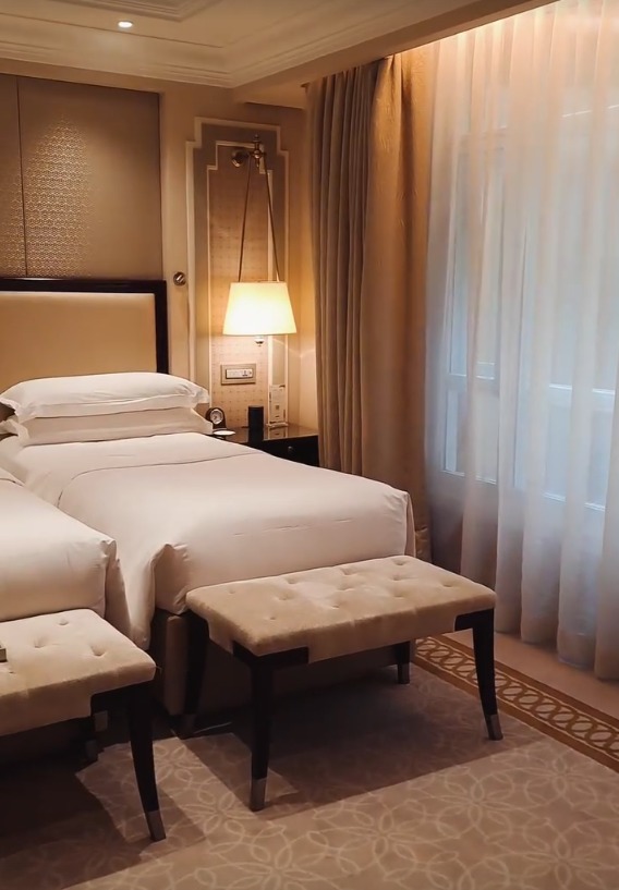 Our hotel room with twin beds and soft lighting