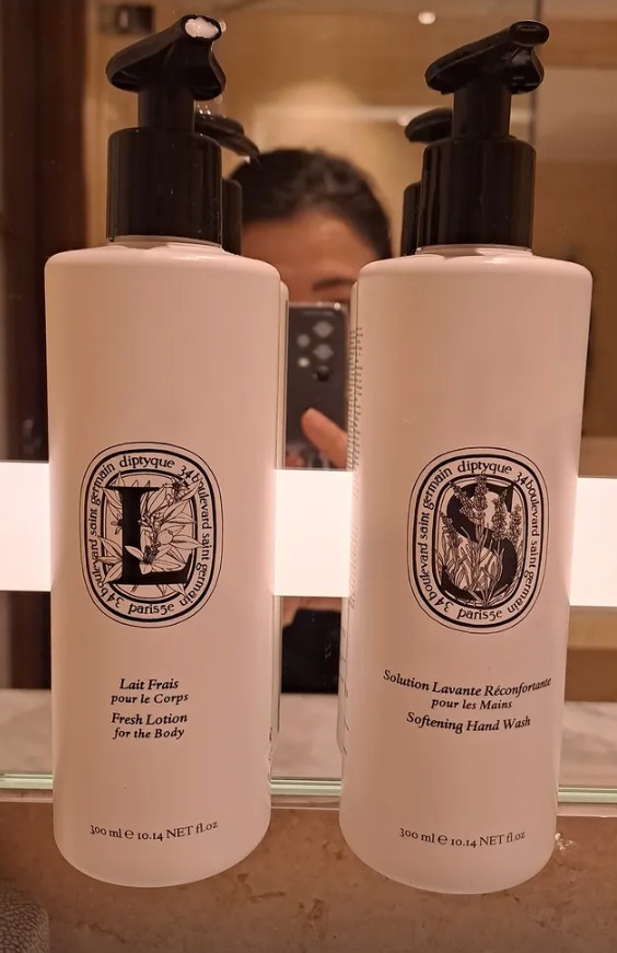 Diptyque body lotion and hand wash in the bathroom