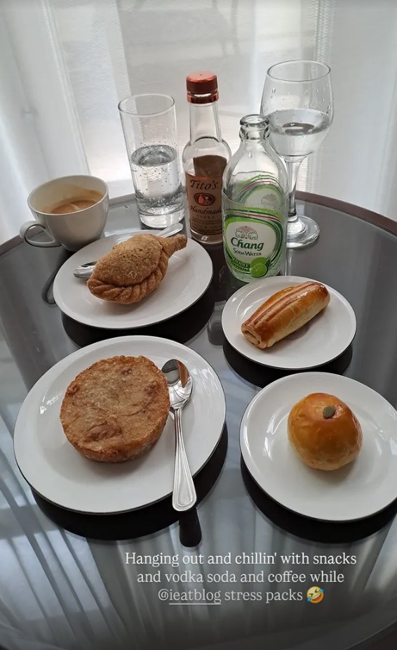 Pastries, coffee and a vodka soda on a glass table
