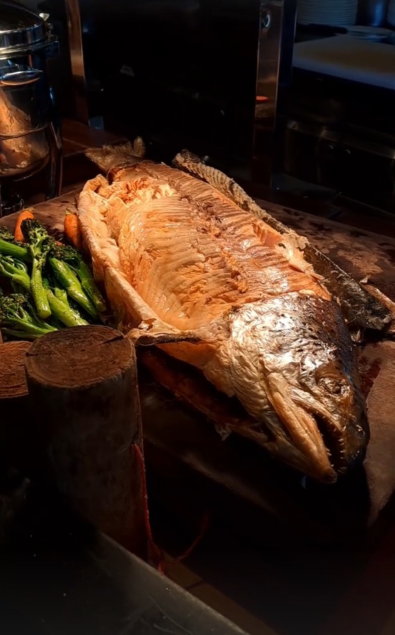 A whole roasted salmon on the buffet