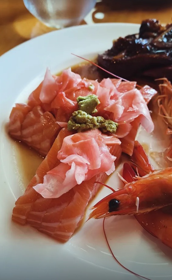 Salmon sashimi with pickled ginger, wasabi and a prawn