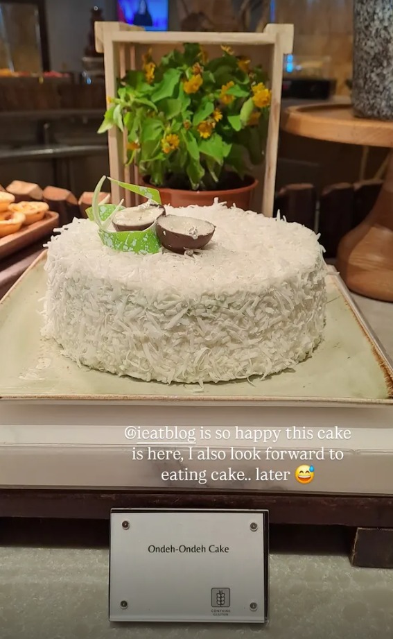 Ondeh ondeh cake covered in coconut on the dessert table