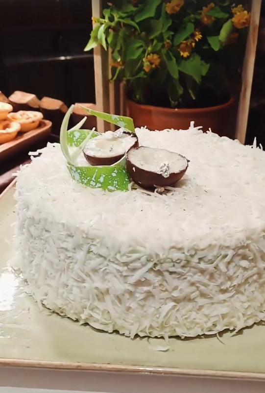 A close-up of the coconut-covered ondeh ondeh cake