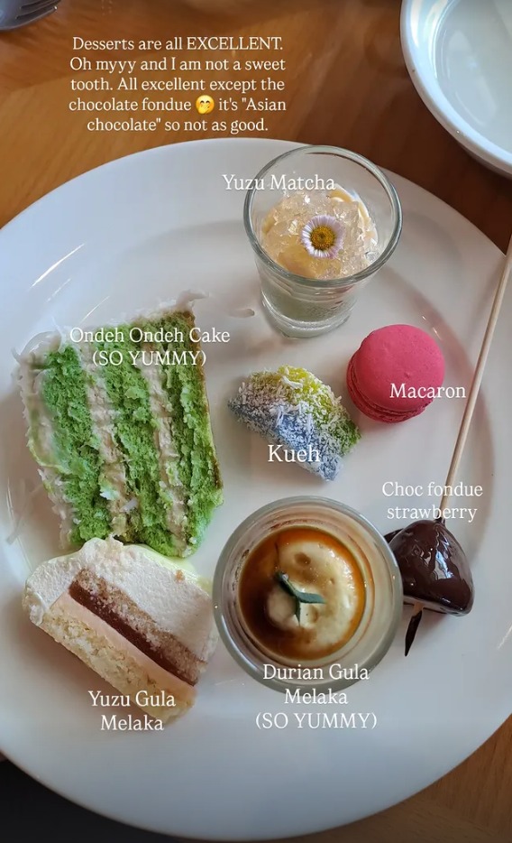 A plate of desserts including ondeh ondeh cake, kueh, a macaron and durian gula melaka