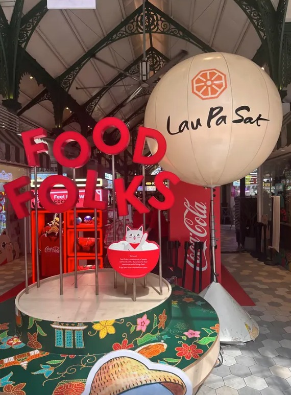The Food Folks display and Lau Pa Sat lantern inside the market