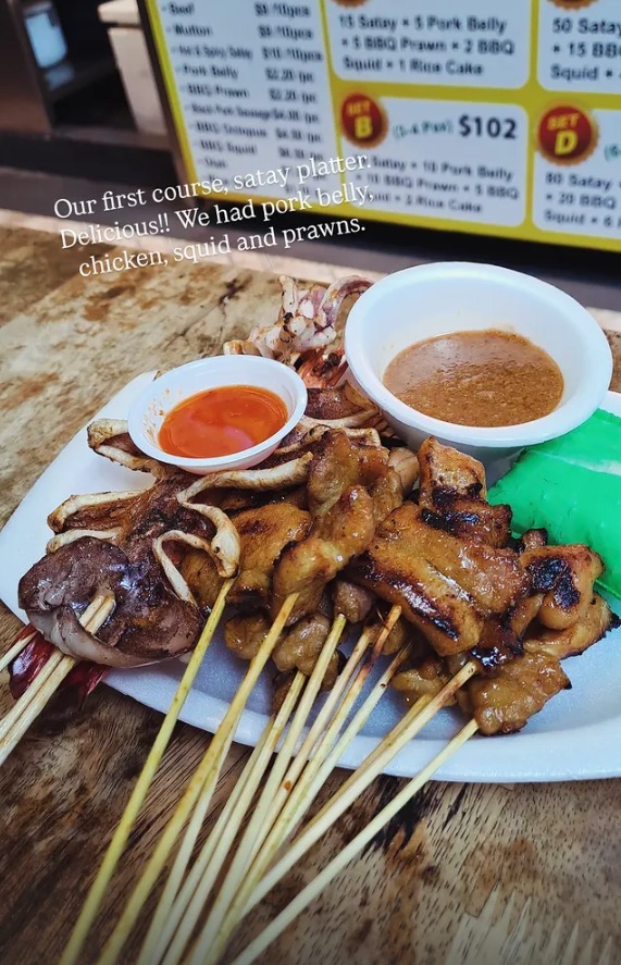 A satay platter of pork belly, chicken, squid and prawns with dipping sauces