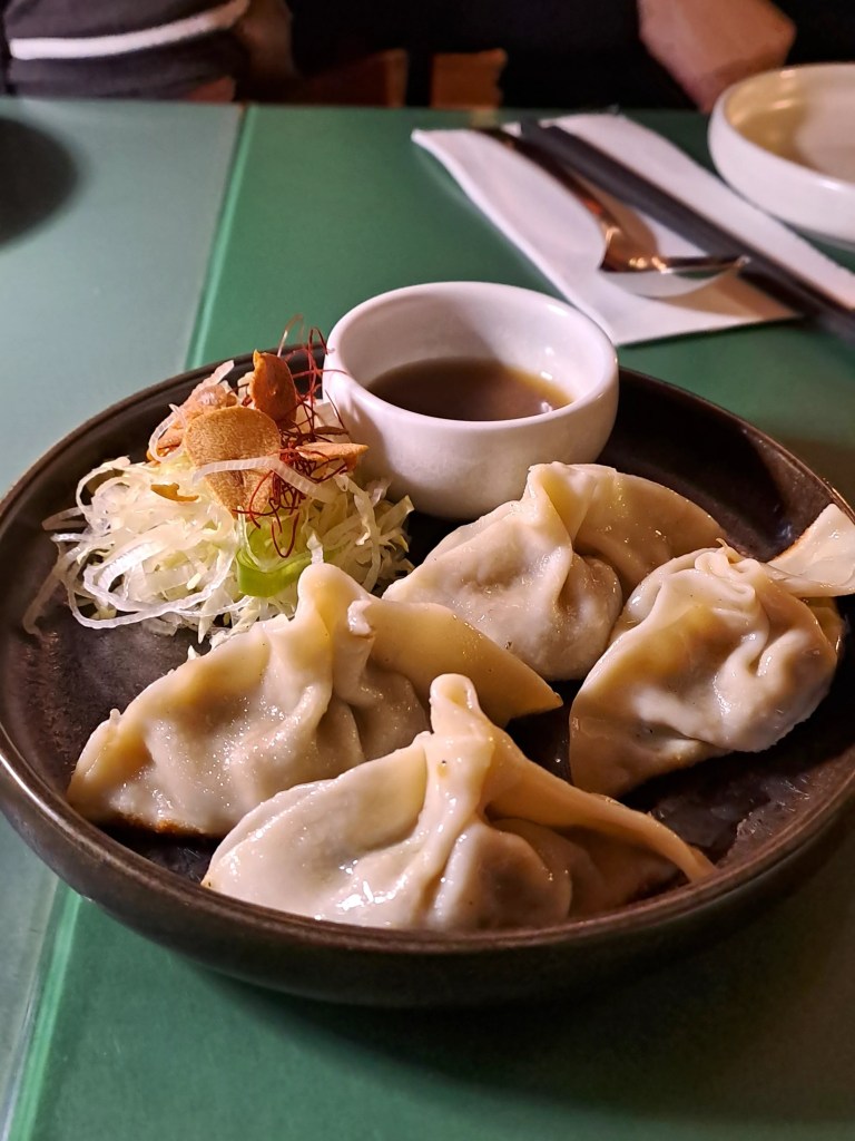Plate of dumplings with dipping sauce