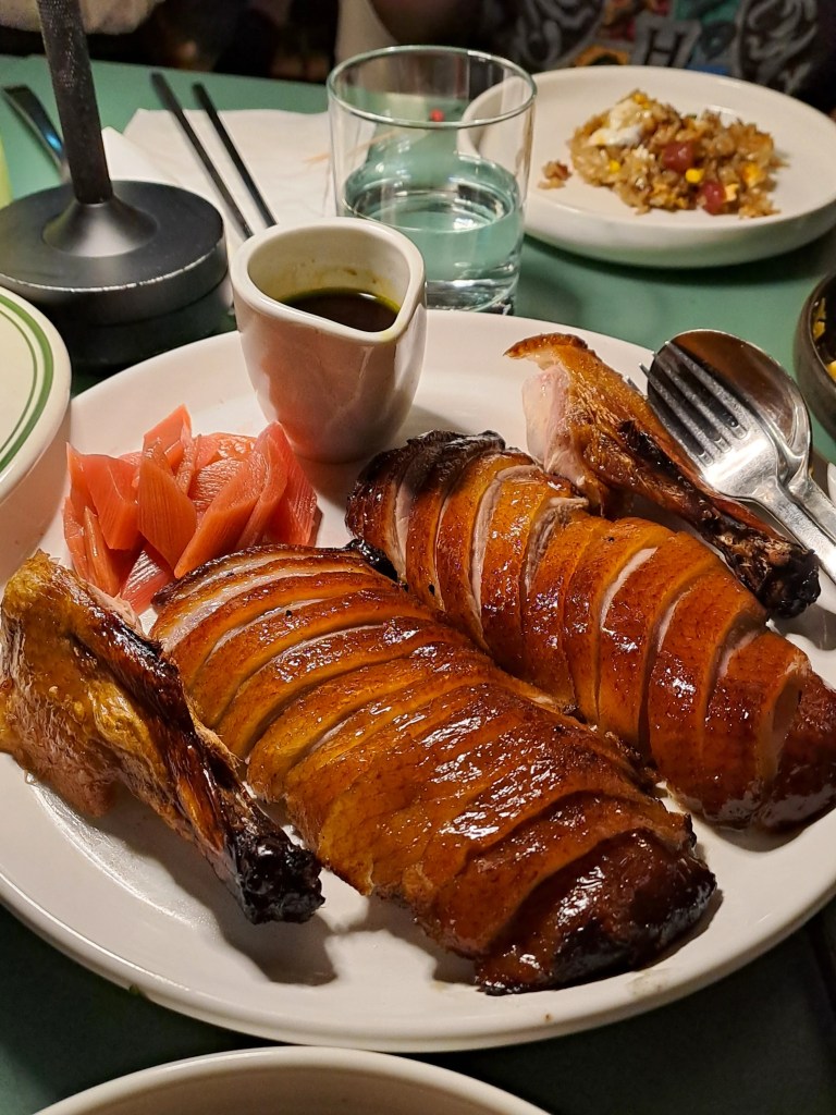Glossy glazed roast meat with pickles at Yum Sing House