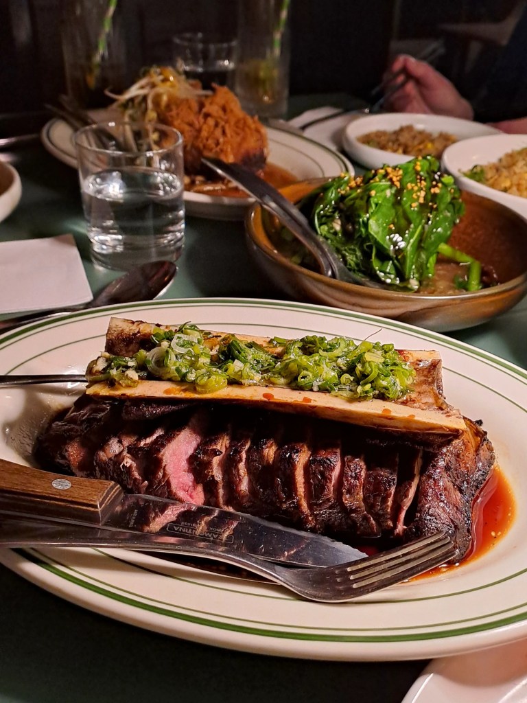 Sliced steak topped with green sauce at Yum Sing House